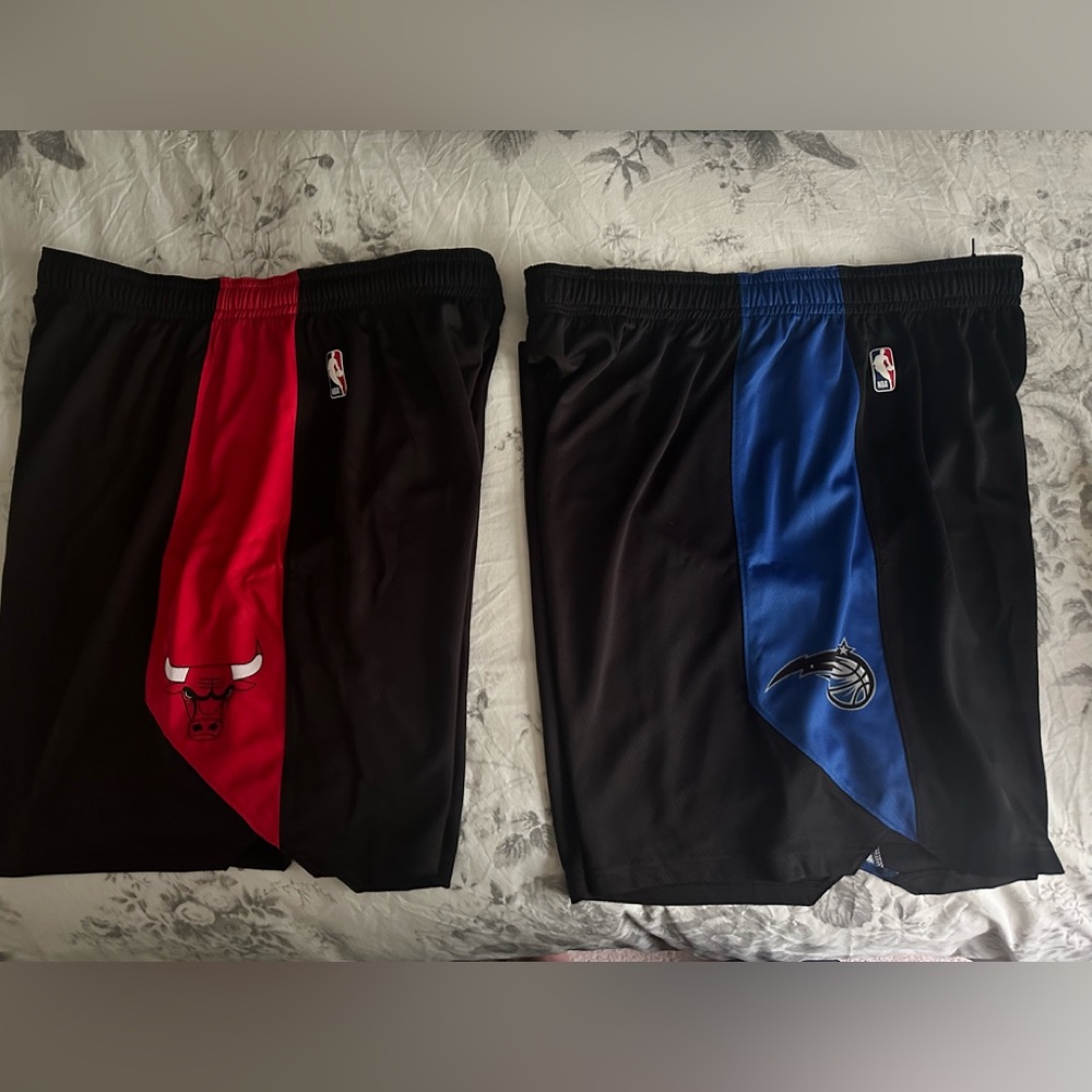 Two pairs of Nike Orlando magic and Chicago bulls practice shorts.